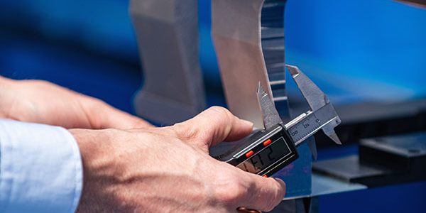 metal-fabrication Metal Fabrication - Calibrating a Machine | Elite Welding & Fabrication