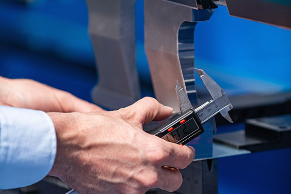 metal-fabrication Metal Fabrication - Calibrating a Machine | Elite Welding & Fabrication