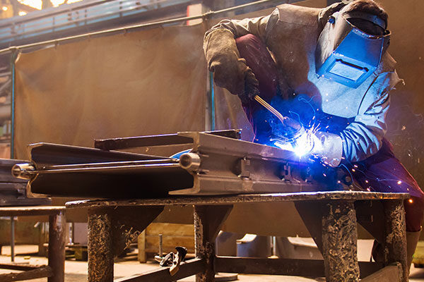 welding Welder at Work With Industrial Welding Helmet | Elite Welding & Fabrication