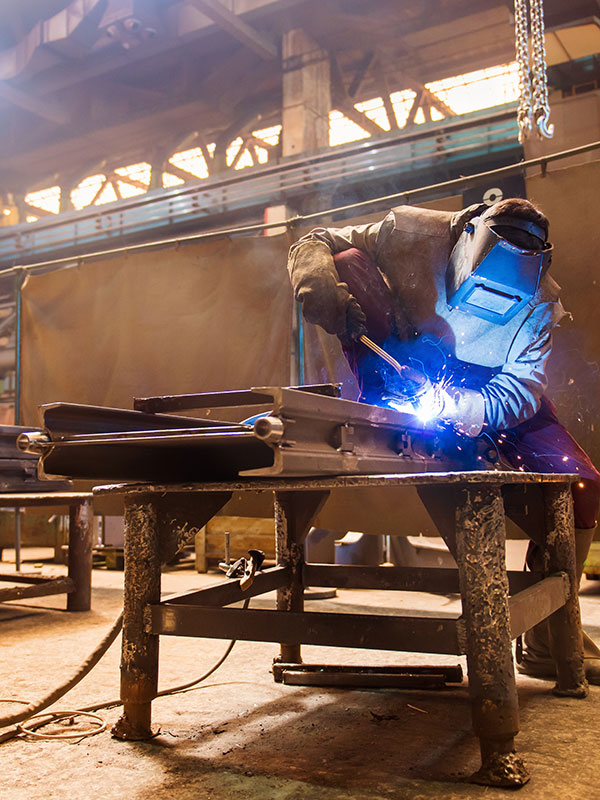 Welder at Work With Industrial Welding Helmet | Elite Welding & Fabrication