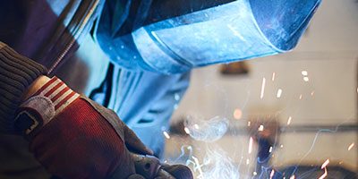 mig-welding Man providing onsite welding services with a MIG welding gun to repair an item | Elite Welding & Fabrication