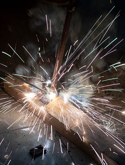 Stick Welding Image With Sparks Flying | Elite Welding & Fabrication