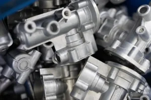 Close up shot of aluminum casting metal products in a pile.