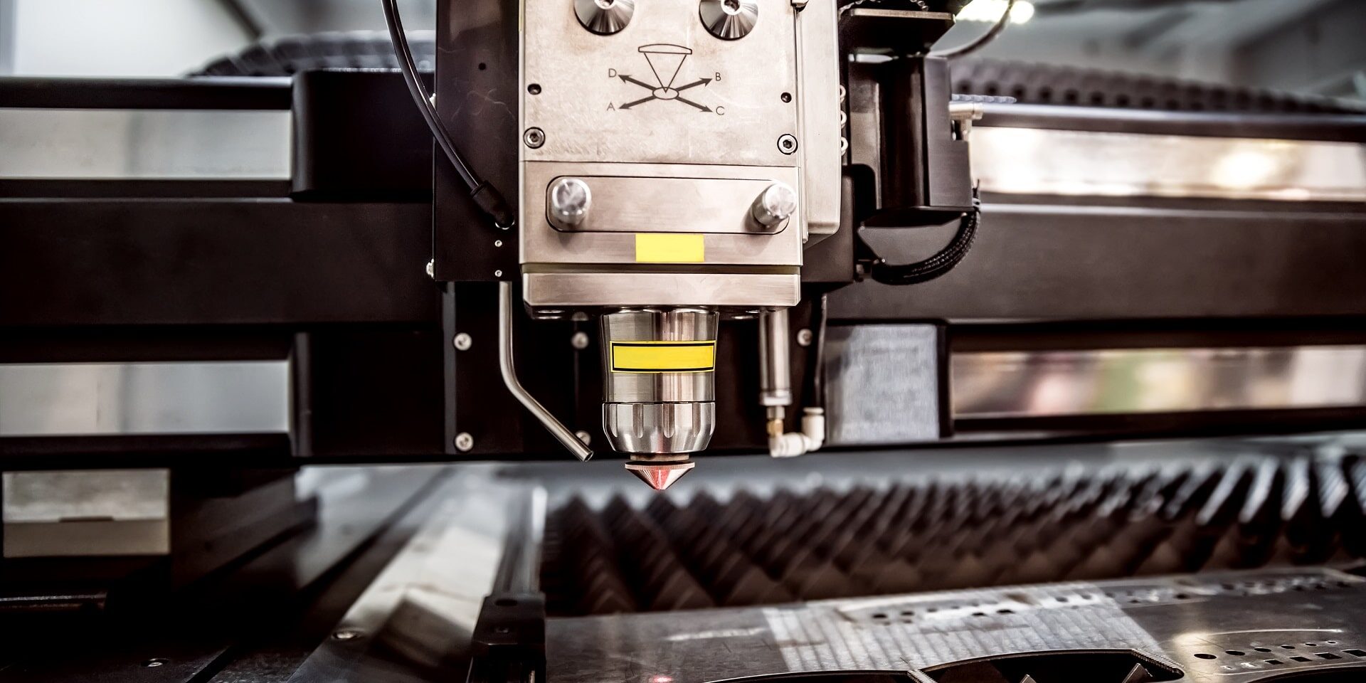 cnc-laser-cutting-of-metal-modern-industrial-tech-2023-11-27-05-14-25-utc-min Close up of a CNC laser cutting machine welding a piece of metal into component parts.