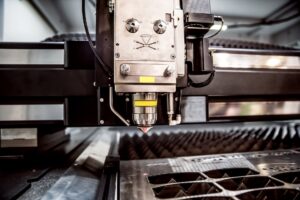 Close up of a CNC laser cutting machine welding a piece of metal into component parts.
