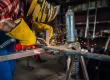 Worker in a workshop welding metal for a custom steel fabrication project.