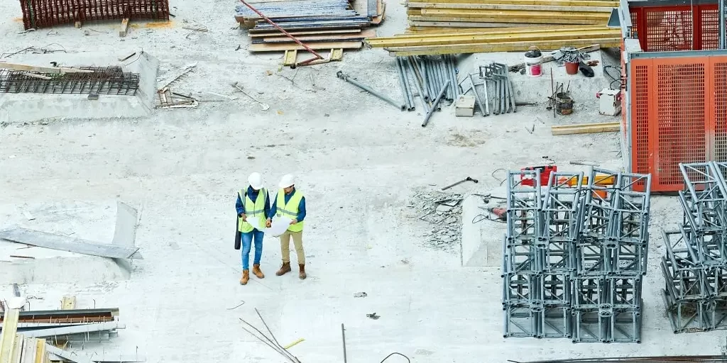 building-inspectors-reading-blueprint-on-construct-2025-03-08-17-11-21-utc-min Building inspectors reading a blueprint on a construction site.
