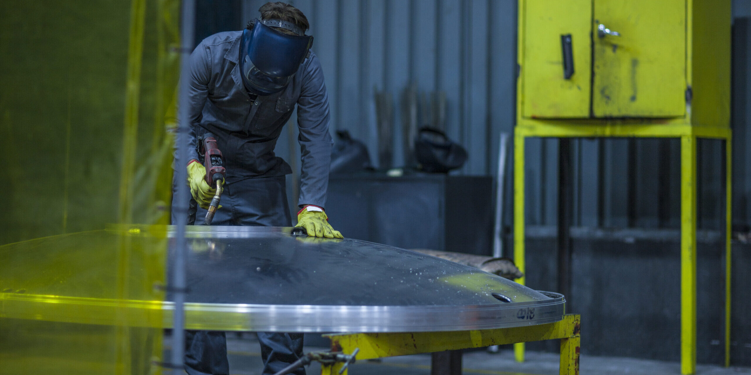Worker welding in factory Worker welding in factory
