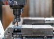 Machines from the metal industrial factory in the numerical control sector, high-tech milling machine that cuts metal with liquid coolant.