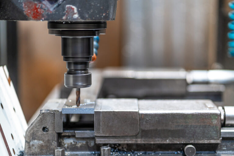 Machines from the metal industrial factory in the numerical control sector, high-tech milling machine that cuts metal with liquid coolant.